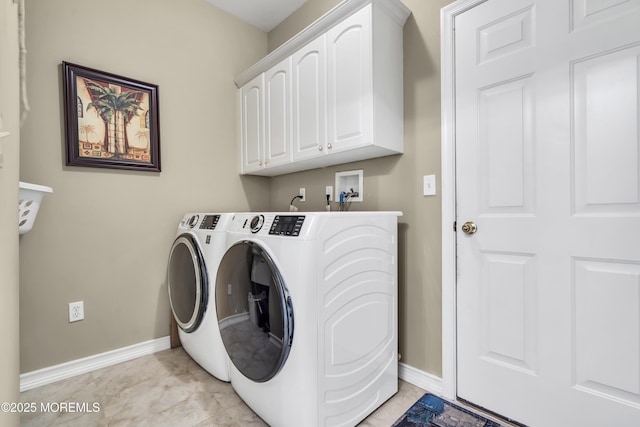 clothes washing area featuring cabinets and independent washer and dryer