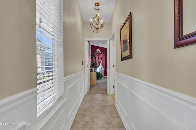 corridor with a notable chandelier