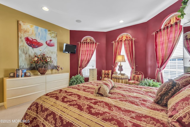 bedroom with multiple windows and carpet flooring