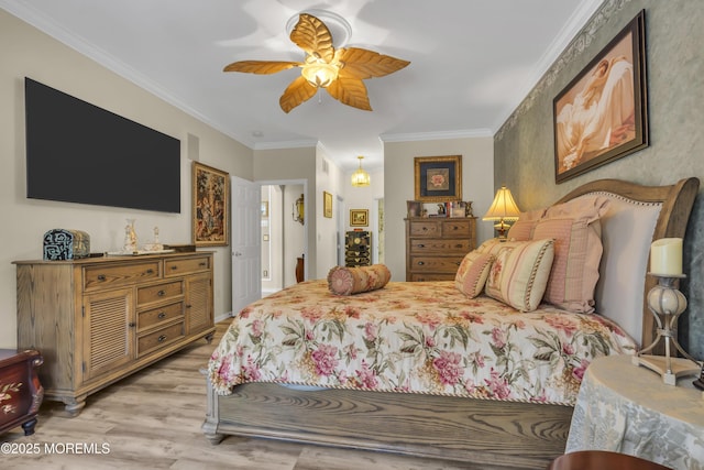 bedroom with ornamental molding, ceiling fan, and light hardwood / wood-style flooring