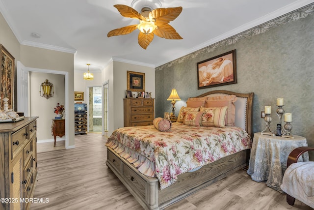 bedroom with crown molding, ceiling fan with notable chandelier, and light wood-type flooring