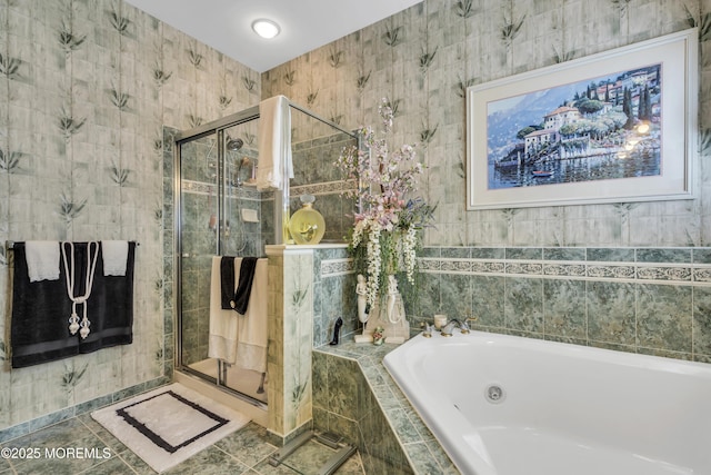 bathroom featuring tile walls and independent shower and bath