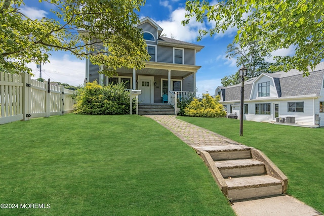 view of front facade featuring covered porch and a front yard