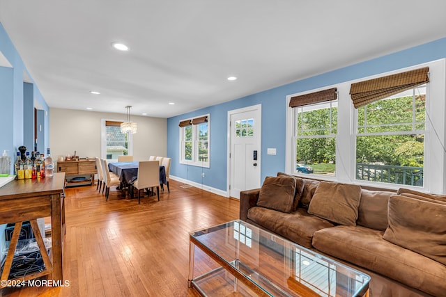 living room with hardwood / wood-style floors and an inviting chandelier