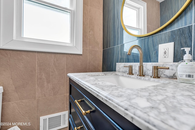 bathroom featuring tile walls and vanity