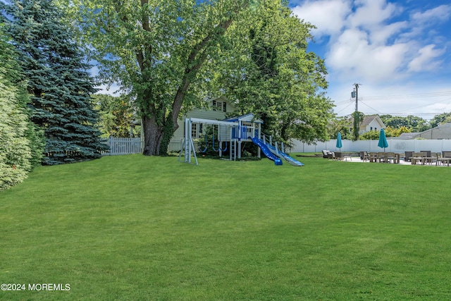 view of yard with a playground and a patio