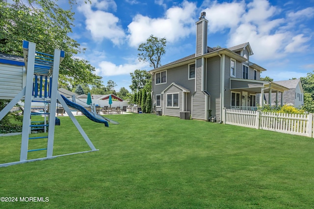 exterior space with a lawn and central air condition unit