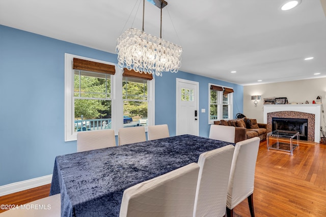 dining area featuring hardwood / wood-style flooring and a notable chandelier