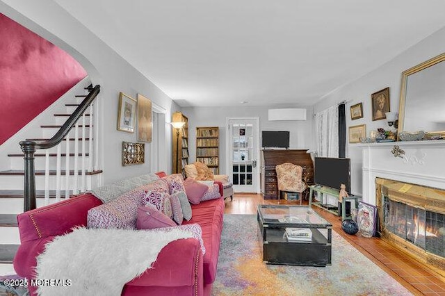 living room featuring wood-type flooring and a wall unit AC