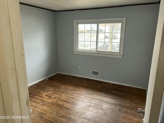 spare room featuring dark wood-type flooring