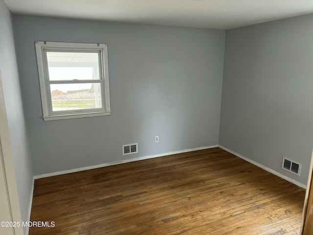 unfurnished room with hardwood / wood-style floors