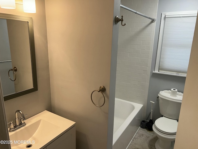 full bathroom with tiled shower / bath, vanity, and toilet