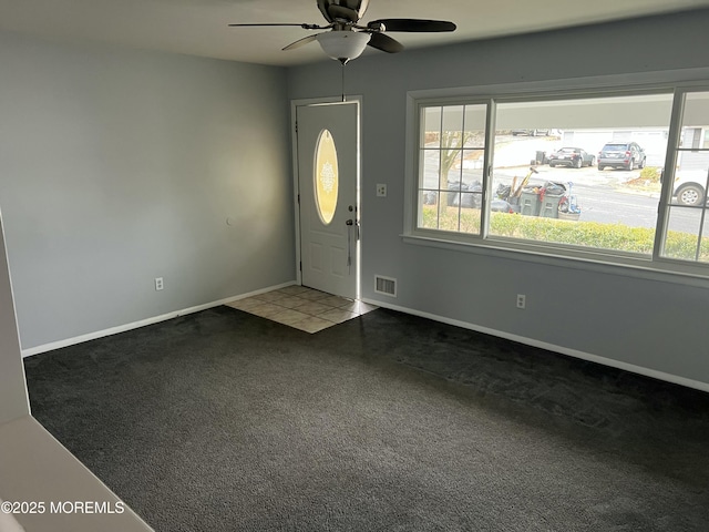 carpeted foyer with ceiling fan