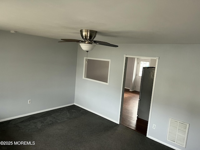 carpeted spare room with ceiling fan