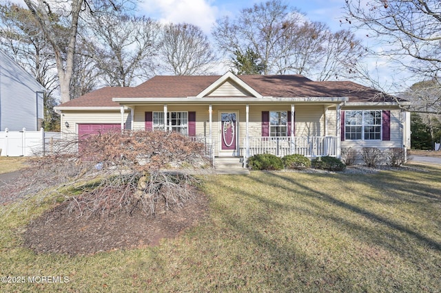 single story home with a porch, a garage, and a front yard