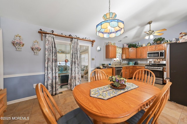 dining room with lofted ceiling, sink, ceiling fan, and light tile patterned flooring