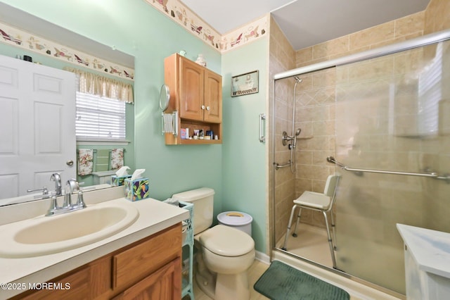 bathroom featuring vanity, toilet, and walk in shower