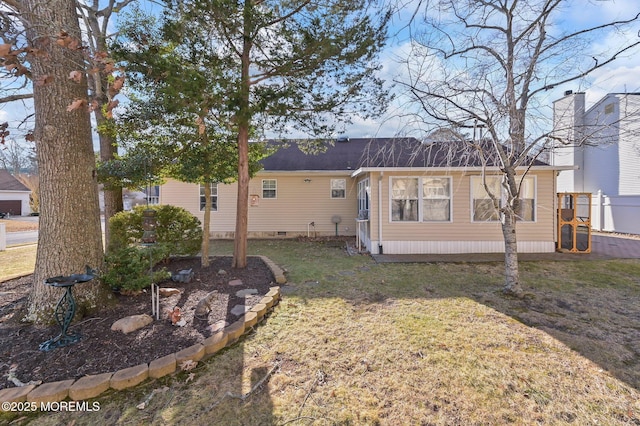 rear view of property featuring a yard