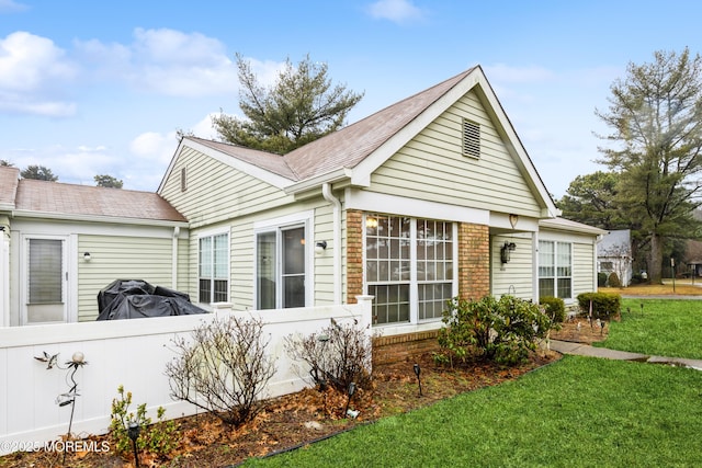 view of side of home featuring a yard