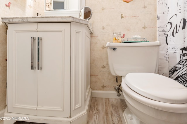 bathroom featuring hardwood / wood-style flooring and toilet