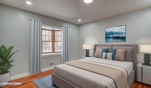 bedroom featuring recessed lighting, wood finished floors, visible vents, and baseboards