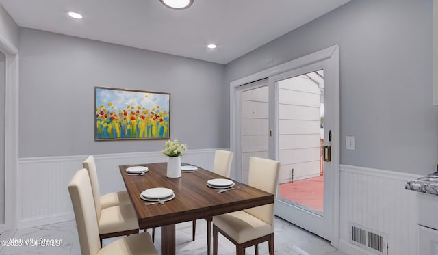 dining area featuring recessed lighting, a wainscoted wall, marble finish floor, and visible vents