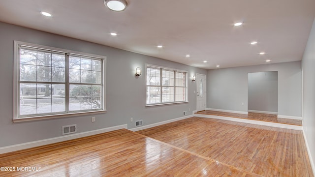 spare room with visible vents, recessed lighting, and wood finished floors