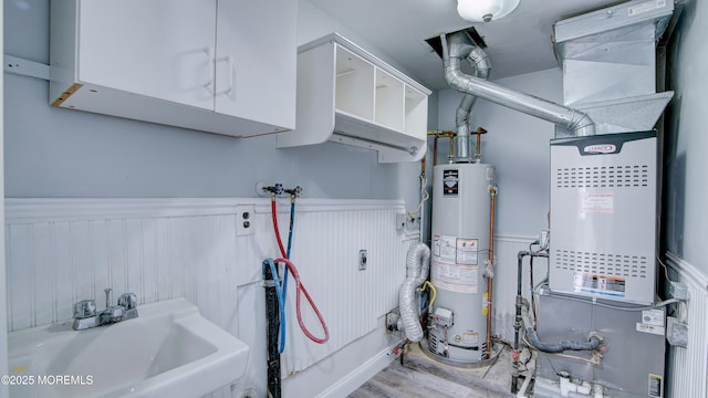 utility room featuring sink and gas water heater