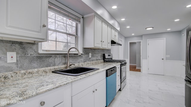 kitchen featuring a sink, under cabinet range hood, marble finish floor, dishwasher, and stainless steel gas stove