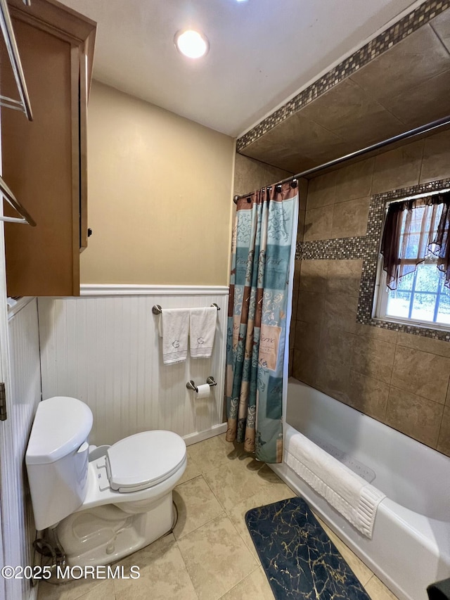 bathroom with shower / bath combo, tile patterned floors, and toilet