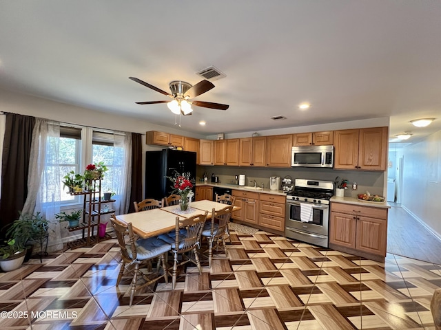 kitchen with ceiling fan and black appliances