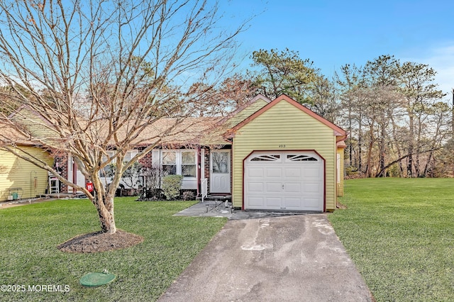 view of front of property featuring a garage and a front lawn