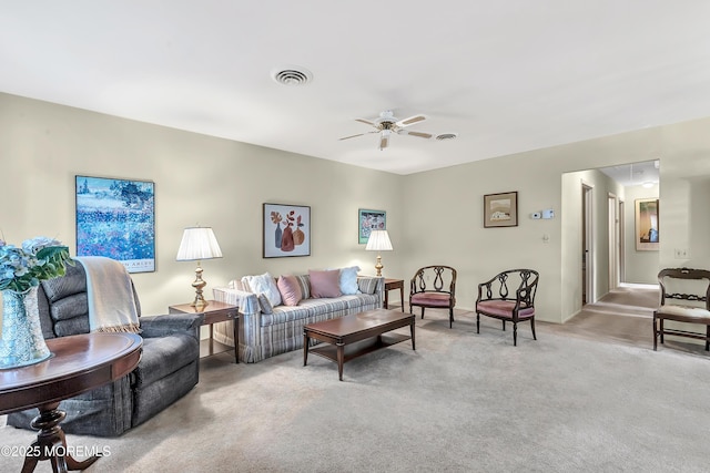 carpeted living room with ceiling fan