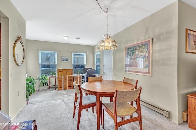 carpeted dining area featuring a baseboard radiator and a notable chandelier