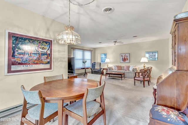 dining room featuring light carpet and ceiling fan