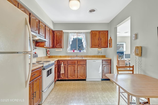 kitchen featuring sink and white appliances