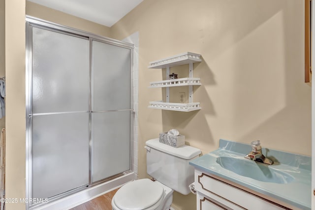 bathroom with vanity, toilet, and an enclosed shower