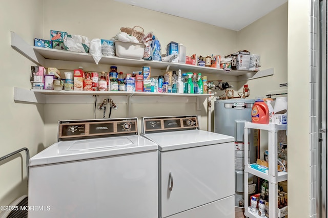 laundry room featuring water heater and separate washer and dryer