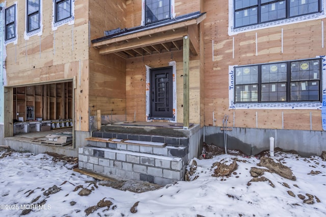 view of snow covered property entrance