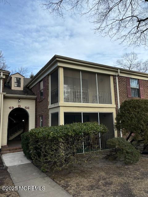 view of front of house featuring a sunroom