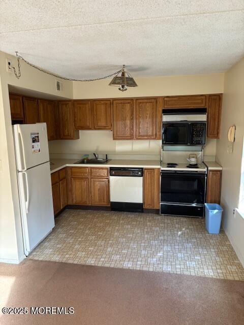 kitchen featuring light carpet, sink, white appliances, and a textured ceiling