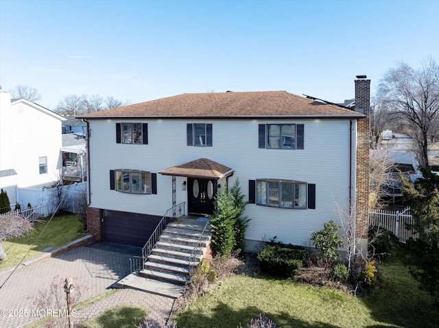 view of front of house with a garage and a front yard