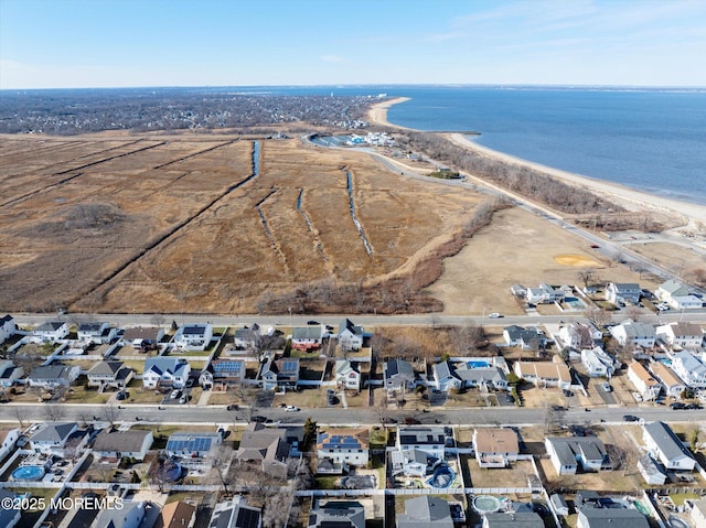 birds eye view of property with a beach view and a water view