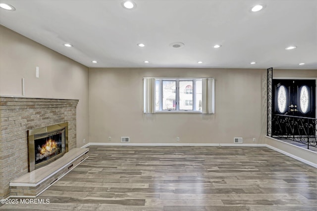 unfurnished living room featuring a fireplace and light wood-type flooring