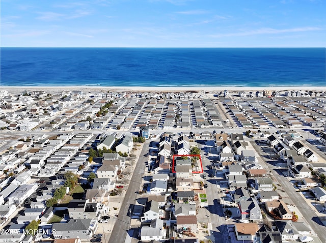 bird's eye view featuring a water view and a view of the beach