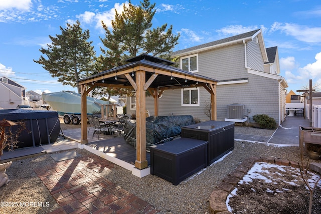 back of property featuring cooling unit and a wooden deck