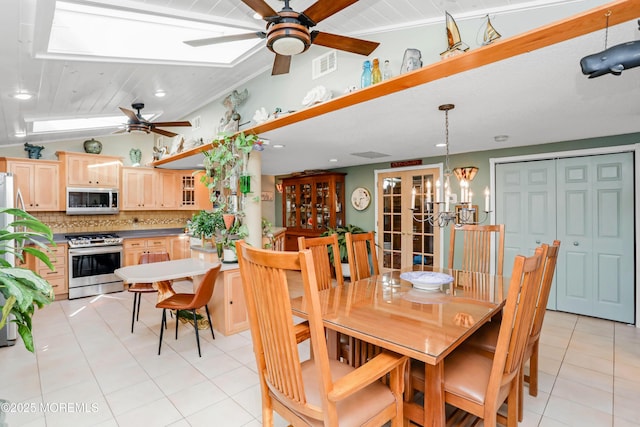 dining room featuring french doors, ceiling fan, vaulted ceiling, and light tile patterned floors