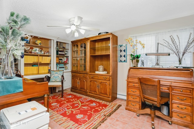 home office featuring baseboard heating, ceiling fan, a textured ceiling, and light tile patterned floors