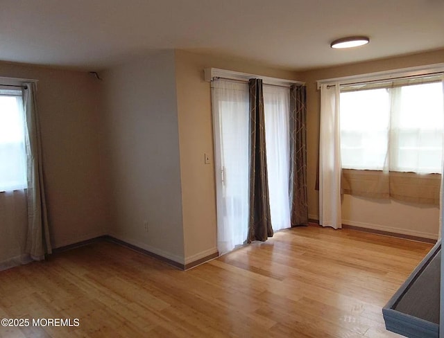 unfurnished room with plenty of natural light and light wood-type flooring