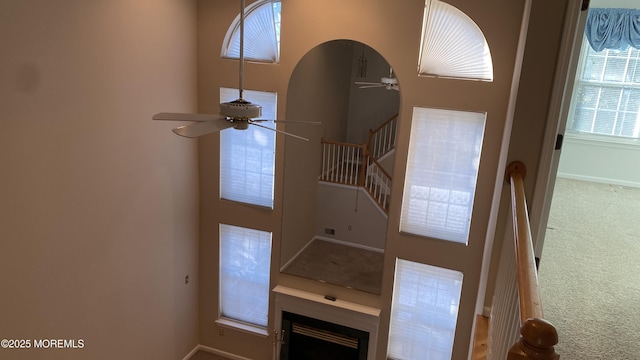 carpeted foyer featuring ceiling fan